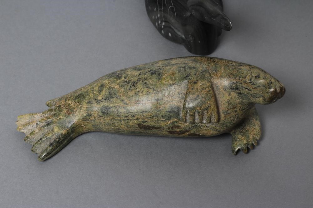 THREE INUIT STONE CARVINGS depicting a seal Image