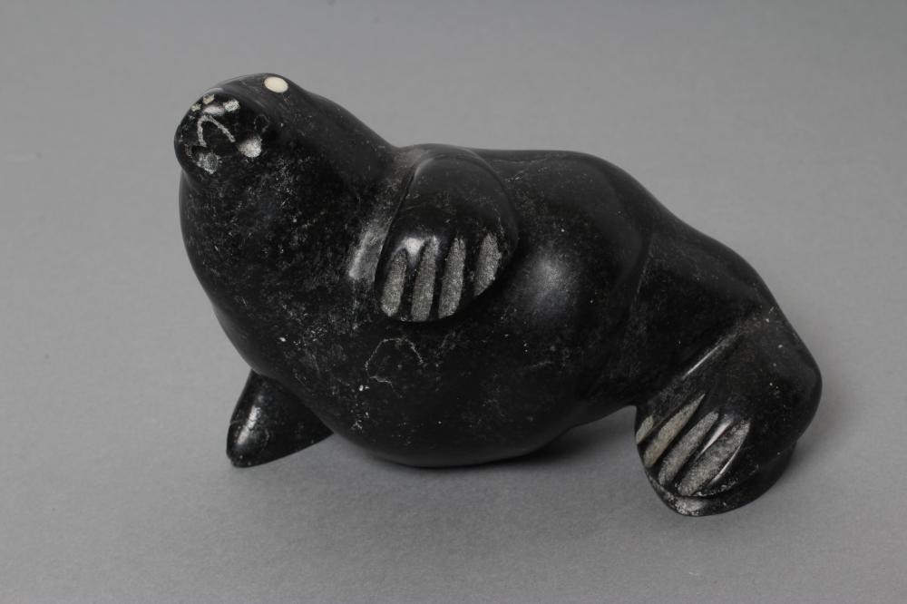 THREE INUIT STONE CARVINGS depicting a seal Image