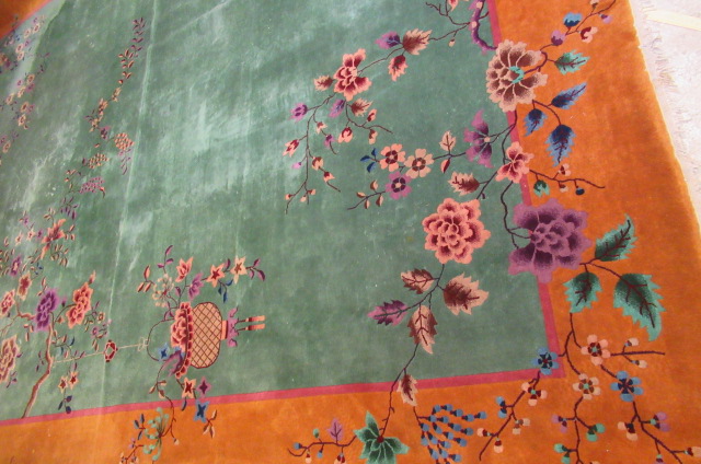 A LARGE CHINESE WASHED AND FRINGED CARPET Image