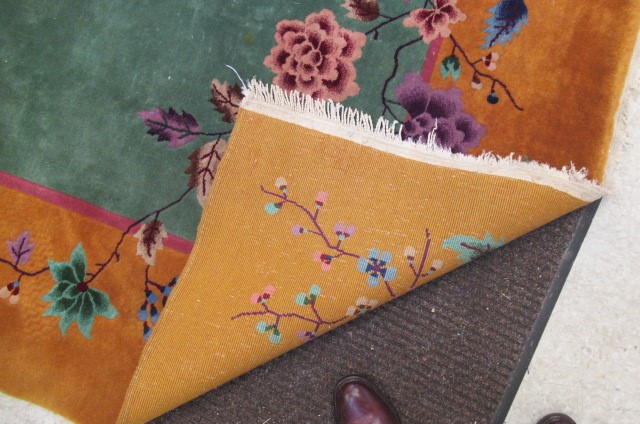 A LARGE CHINESE WASHED AND FRINGED CARPET Image