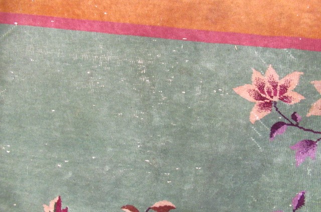 A LARGE CHINESE WASHED AND FRINGED CARPET Image