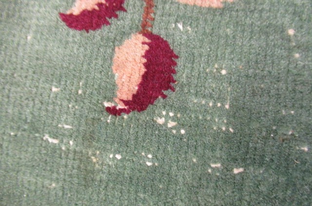 A LARGE CHINESE WASHED AND FRINGED CARPET Image