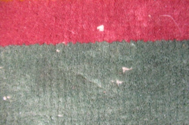 A LARGE CHINESE WASHED AND FRINGED CARPET Image