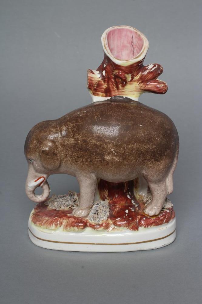 A VICTORIAN STAFFORDSHIRE POTTERY ELEPHANT SPILL VASE modelled standing with two free legs Image