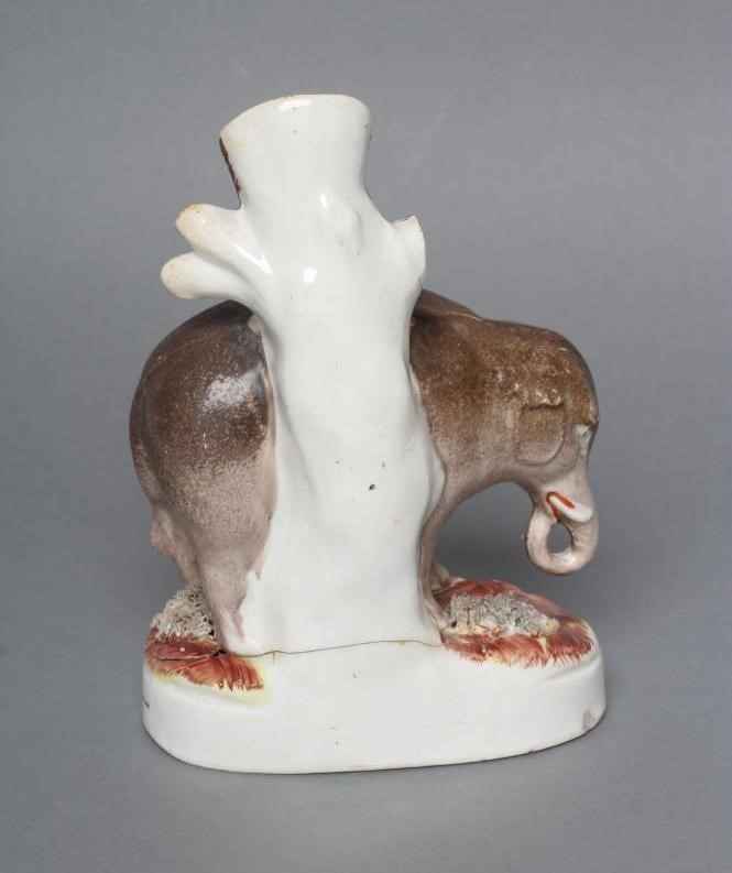 A VICTORIAN STAFFORDSHIRE POTTERY ELEPHANT SPILL VASE modelled standing with two free legs Image
