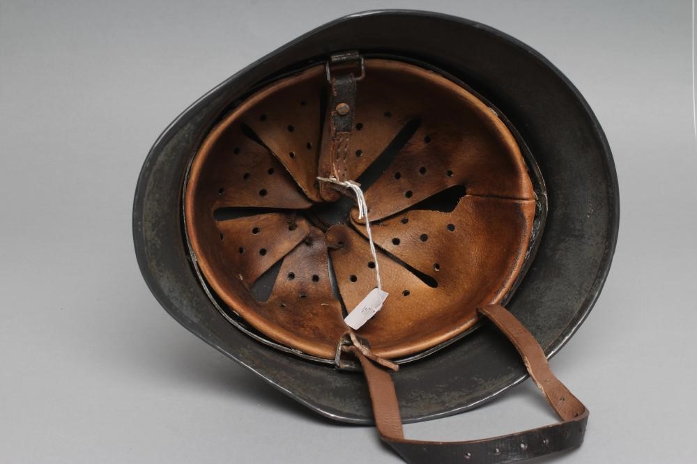 A THIRD REICH M35 ARMY HELMET painted in green with applied shield and reichsadler Image