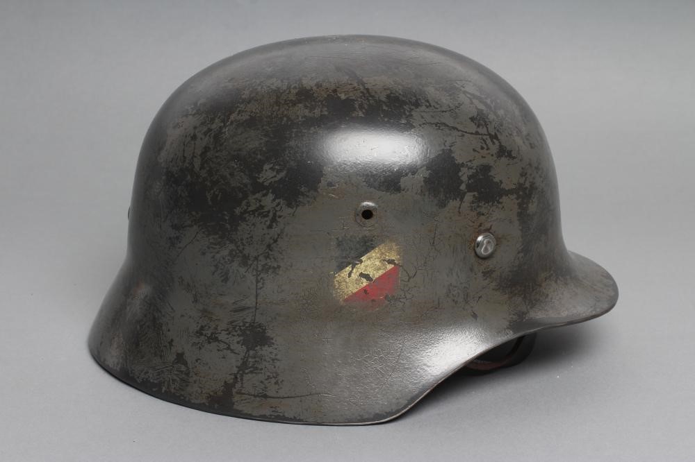 A THIRD REICH M35 ARMY HELMET painted in green with applied shield and reichsadler Image