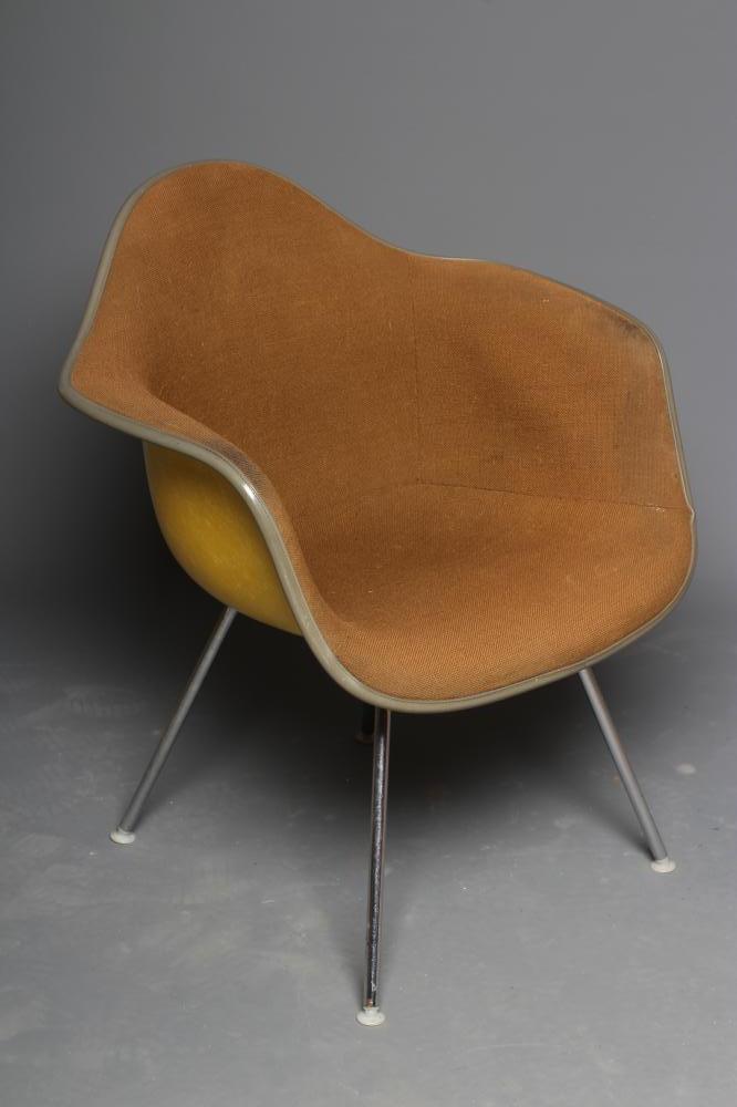 A CHARLES & RAY EAMES FOR HERMAN MILLER SHELL CHAIR in yellow fibre glass with brown woven cushion Image
