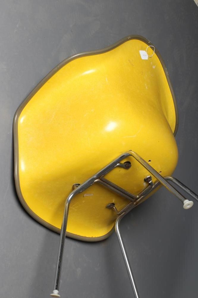 A CHARLES & RAY EAMES FOR HERMAN MILLER SHELL CHAIR in yellow fibre glass with brown woven cushion Image