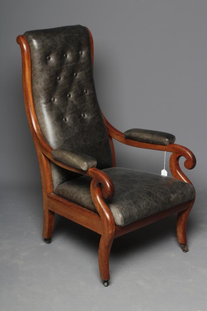A VICTORIAN MAHOGANY ARMCHAIR button upholstered in green leather Image
