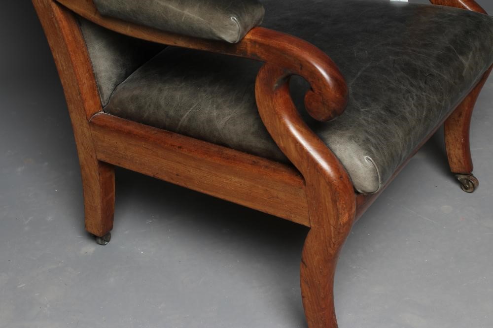 A VICTORIAN MAHOGANY ARMCHAIR button upholstered in green leather Image
