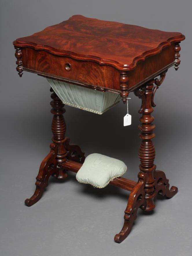 A VICTORIAN MAHOGANY WORK TABLE of serpentine oblong form with turned pendants Image