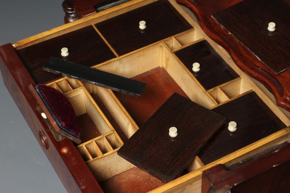 A VICTORIAN MAHOGANY WORK TABLE of serpentine oblong form with turned pendants Image