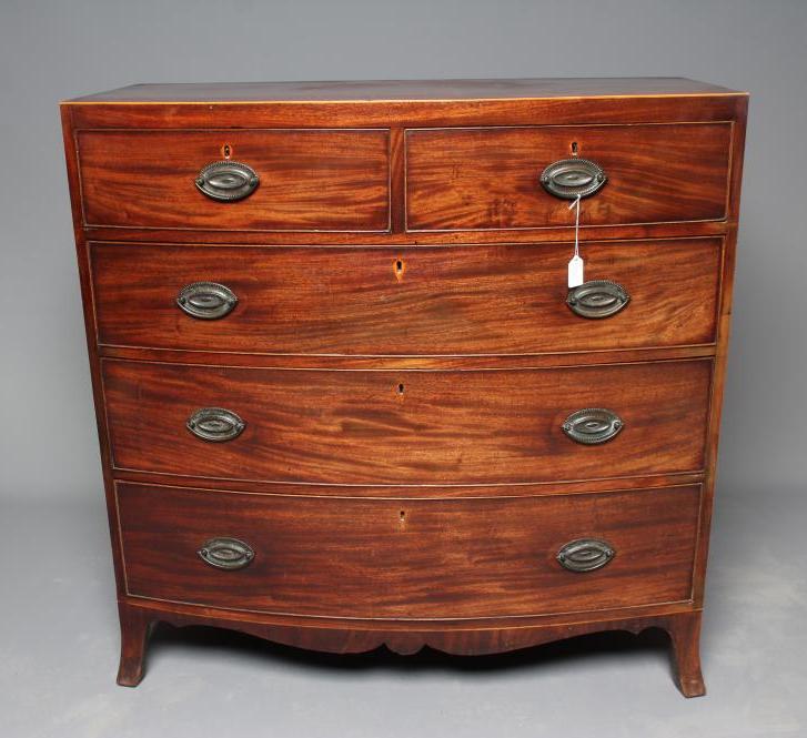 A REGENCY MAHOGANY BOWED CHEST of two short and three long cockbeaded drawers Image