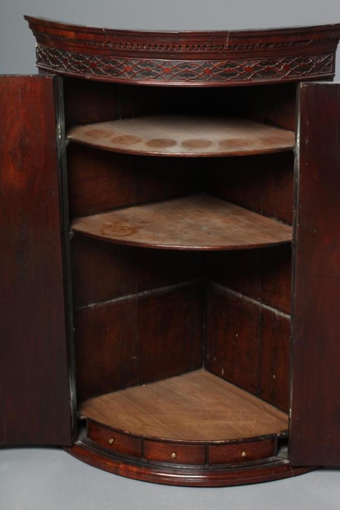 A GEORGIAN MAHOGANY BOWED CORNER CUPBOARD Image