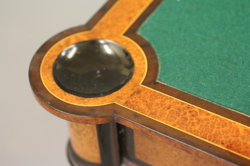 A VICTORIAN AMBOYNA AND EBONISED FOLDING CARD TABLE of earred oblong form with gilt metal mounts Image