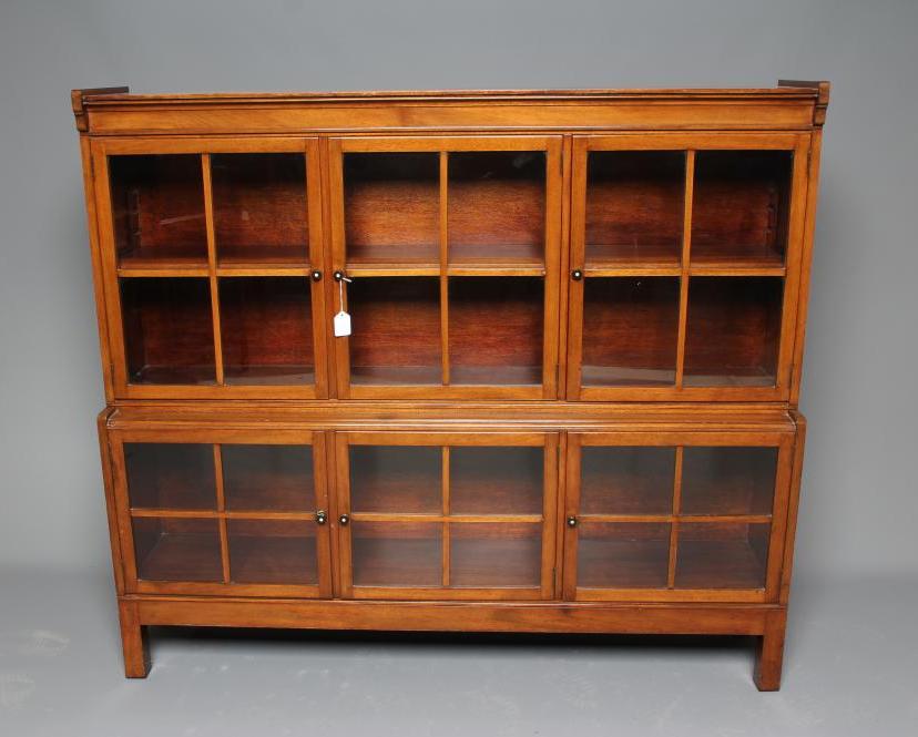 A GLAZED MAHOGANY TWO STAGE BOOKCASE Image