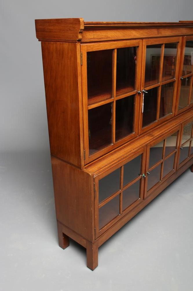 A GLAZED MAHOGANY TWO STAGE BOOKCASE Image