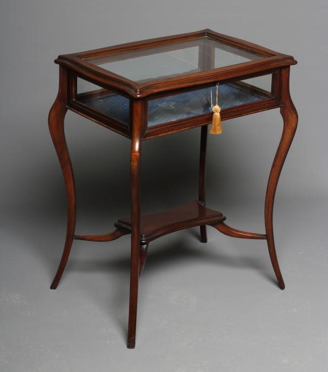 A LATE VICTORIAN MAHOGANY BIJOUTERIE TABLE of oblong serpentine form Image