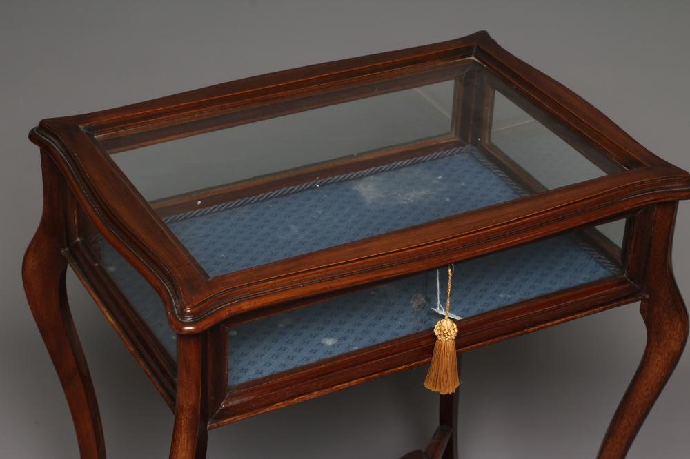 A LATE VICTORIAN MAHOGANY BIJOUTERIE TABLE of oblong serpentine form Image
