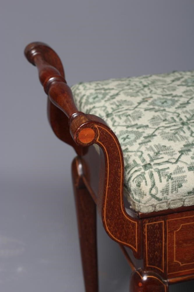 AN EDWARDIAN MAHOGANY PIANO STOOL of oblong form with stringing Image