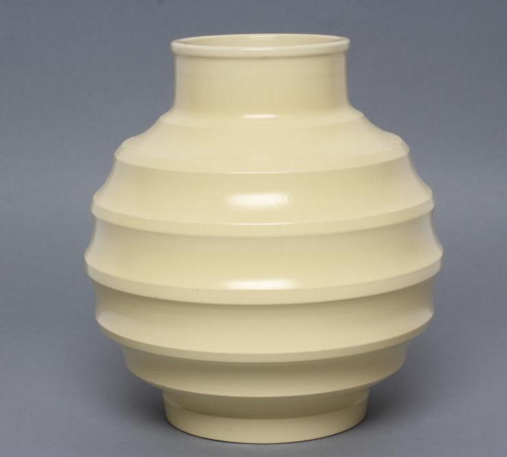 KEITH MURRAY FOR WEDGWOOD - a cream glazed earthenware vase of ribbed spherical form Image
