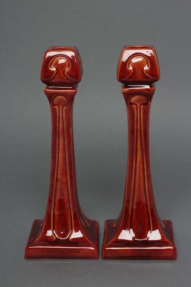 A PAIR OF BURMANTOFTS FAIENCE SECESSIONIST STYLE CANDLESTICKS Image