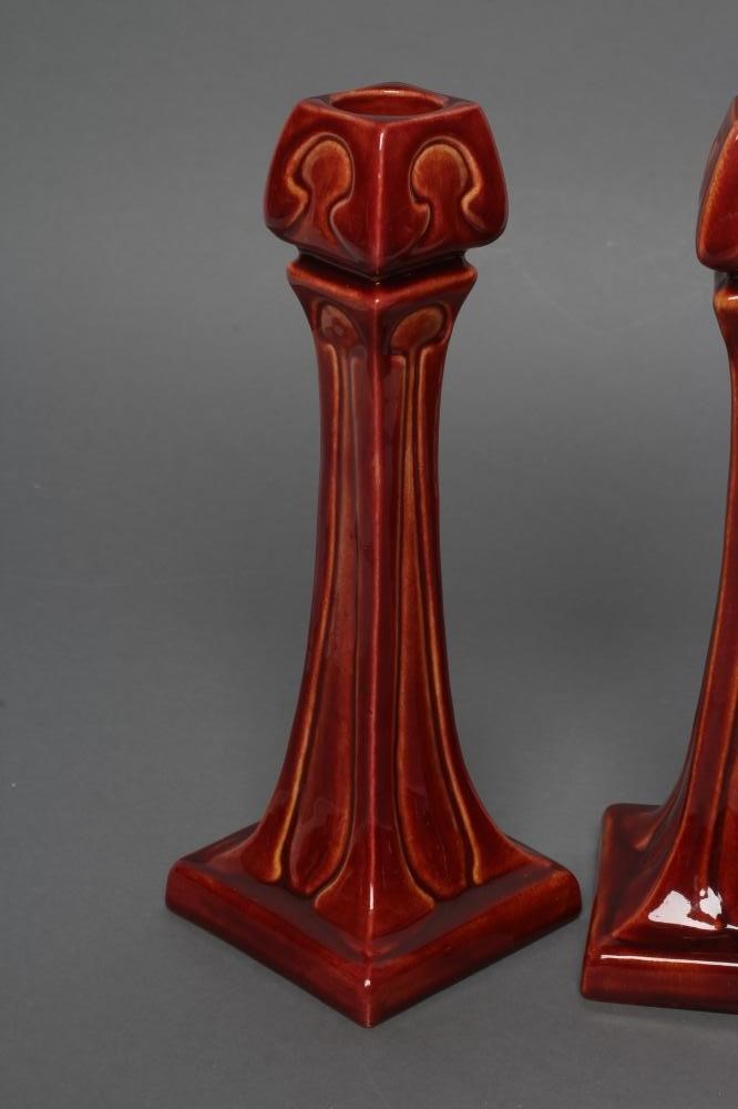 A PAIR OF BURMANTOFTS FAIENCE SECESSIONIST STYLE CANDLESTICKS Image