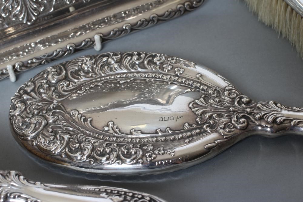 AN EDWARDIAN SILVER FOUR PIECE DRESSING TABLE SET Image