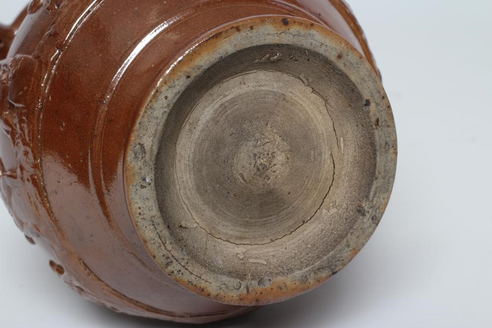 A VICTORIAN BROWN SALT GLAZED STONEWARE PUZZLE JUG of typical form with three spouts Image