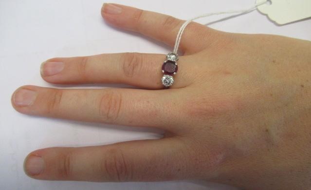 A THREE STONE RUBY AND DIAMOND RING Image