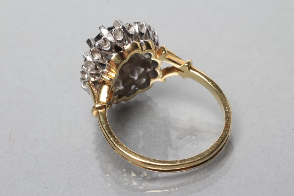 A SAPPHIRE AND DIAMOND CLUSTER RING Image