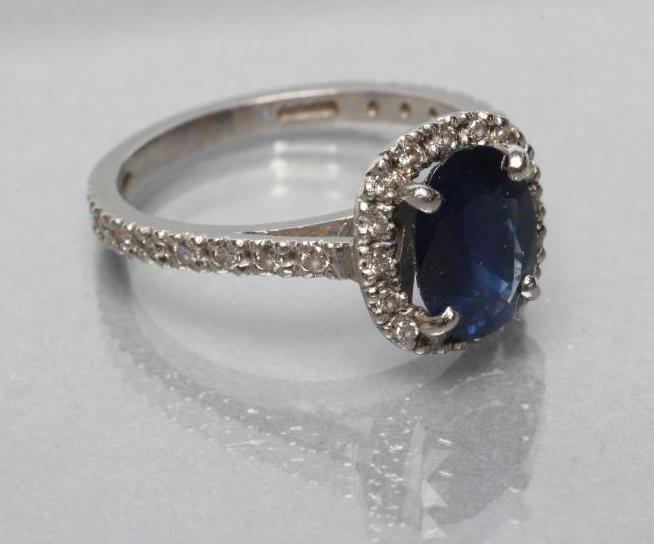 A SAPPHIRE AND DIAMOND CLUSTER RING Image