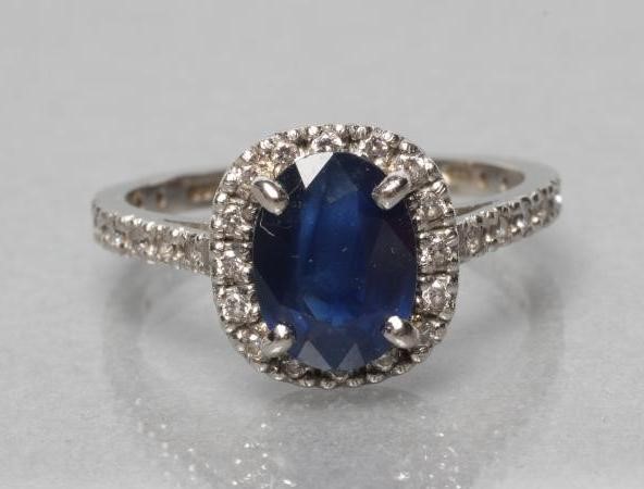 A SAPPHIRE AND DIAMOND CLUSTER RING Image