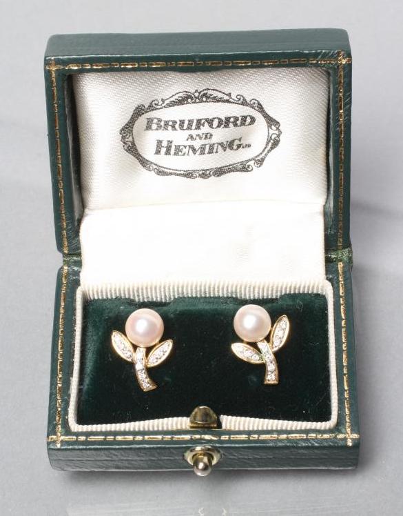 A PAIR OF CULTURED PEARL AND DIAMOND EAR STUDS Image