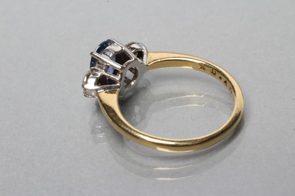 A SAPPHIRE AND DIAMOND THREE STONE RING Image
