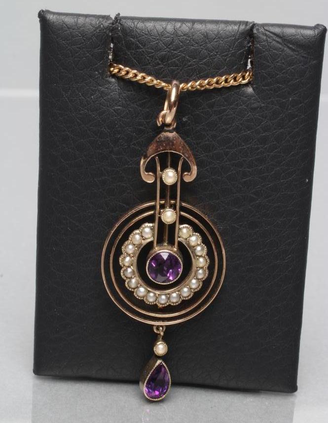 AN EDWARDIAN PENDANT with central collet set circular amethyst and matching tear drop within a Image
