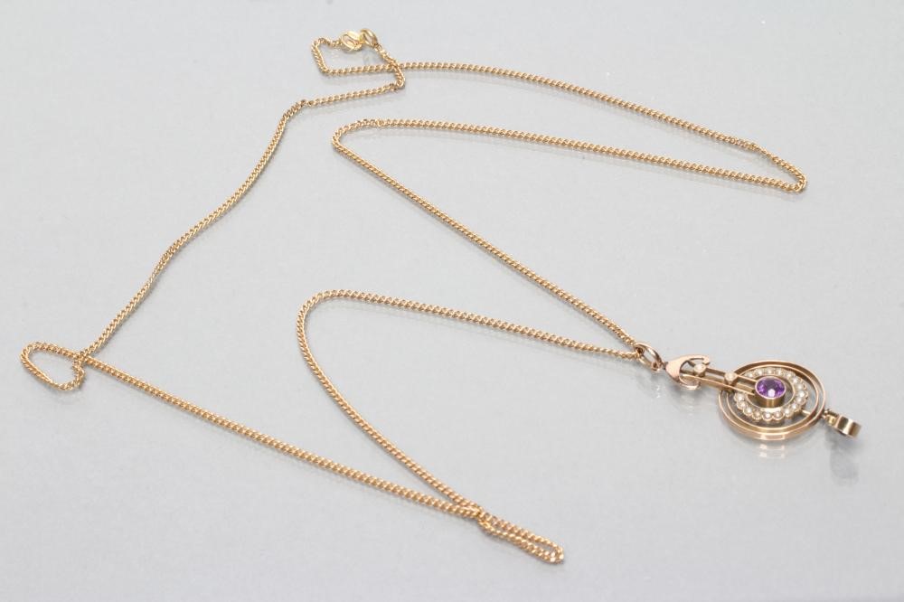 AN EDWARDIAN PENDANT with central collet set circular amethyst and matching tear drop within a Image