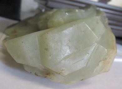 A CHINESE JADE DEITY seated before rockwork with engraved and stained red and gilt script Image