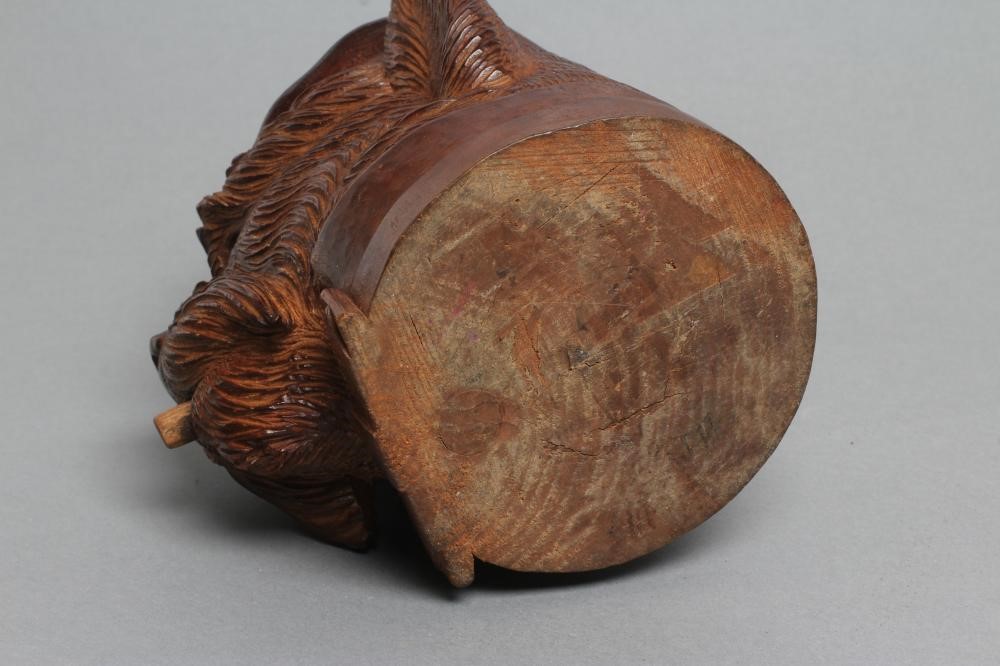 A "BLACK FOREST" CARVED WOOD TOBACCO JAR modelled as a smoking dog's head with glass eyes and hinged Image