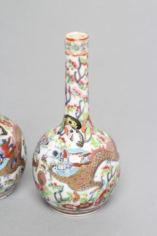 A PAIR OF CHINESE PORCELAIN BOTTLE VASES painted in underglaze blue with a dragon chasing the Image