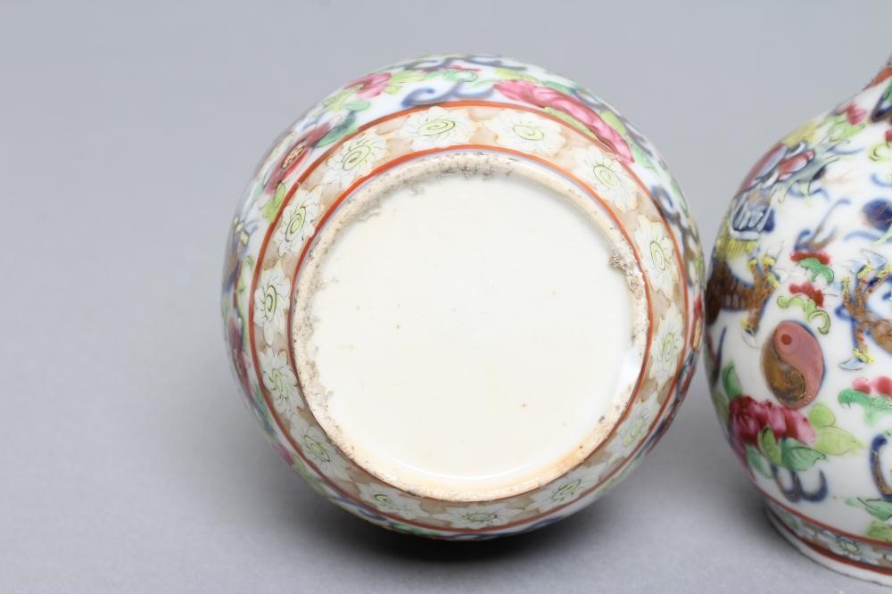 A PAIR OF CHINESE PORCELAIN BOTTLE VASES painted in underglaze blue with a dragon chasing the Image