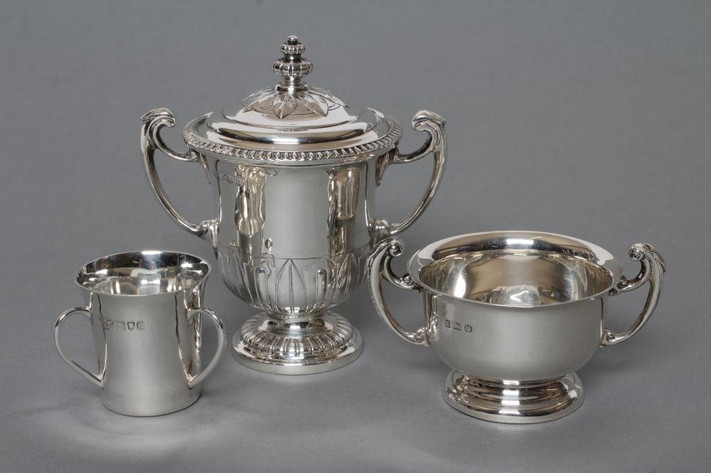 A SMALL TWO HANDLED SILVER TROPHY AND COVER Image