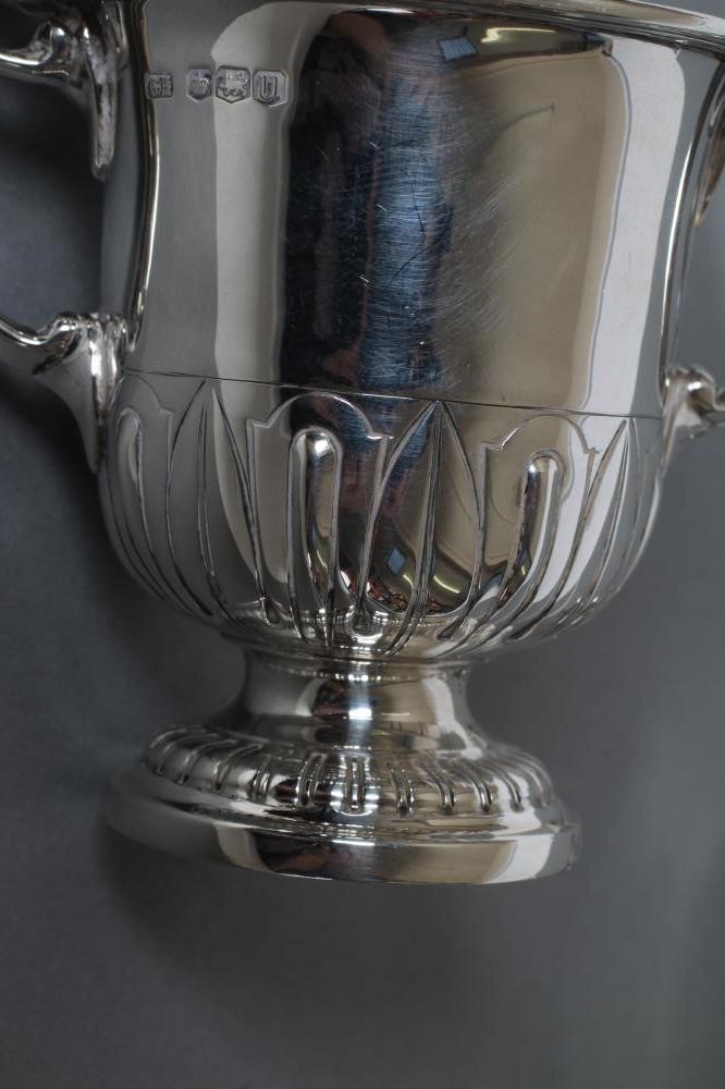 A SMALL TWO HANDLED SILVER TROPHY AND COVER Image