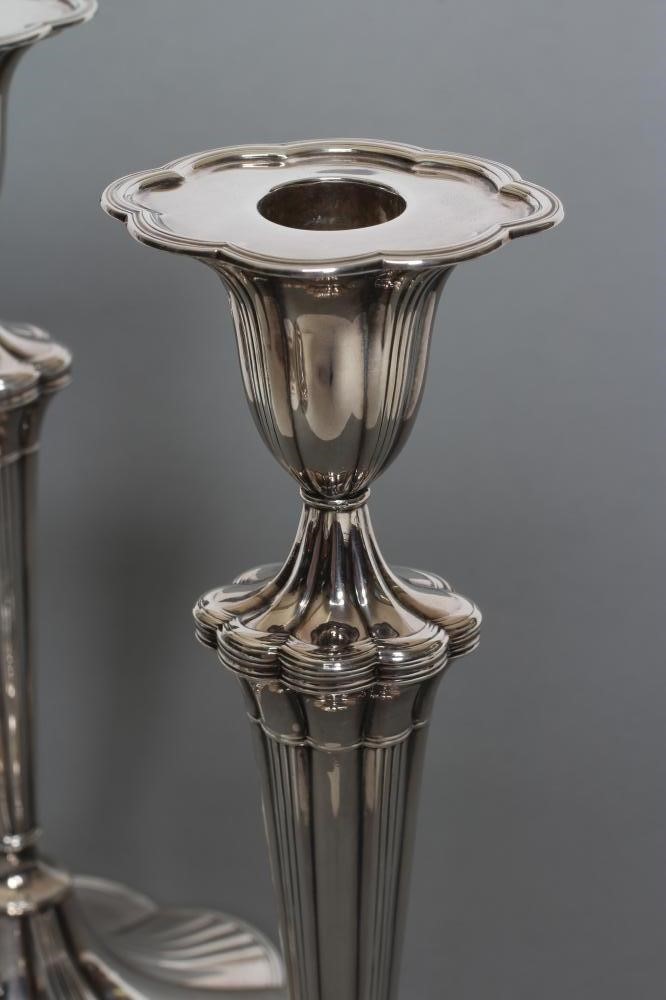 A PAIR OF SILVER CANDLESTICKS Image