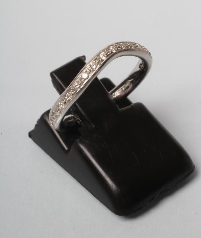 A PLATINUM HALF ETERNITY RING Image