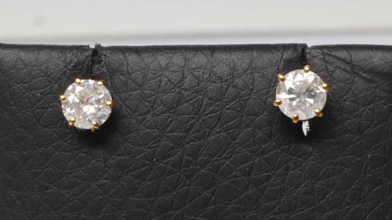 A PAIR OF SOLITAIRE DIAMOND EAR STUDS Image