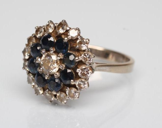 A SAPPHIRE AND DIAMOND CLUSTER RING Image