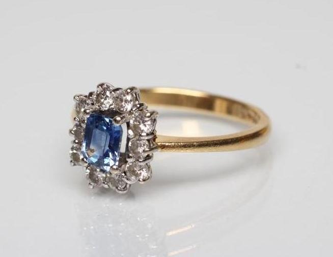 A SAPPHIRE AND DIAMOND CLUSTER RING Image