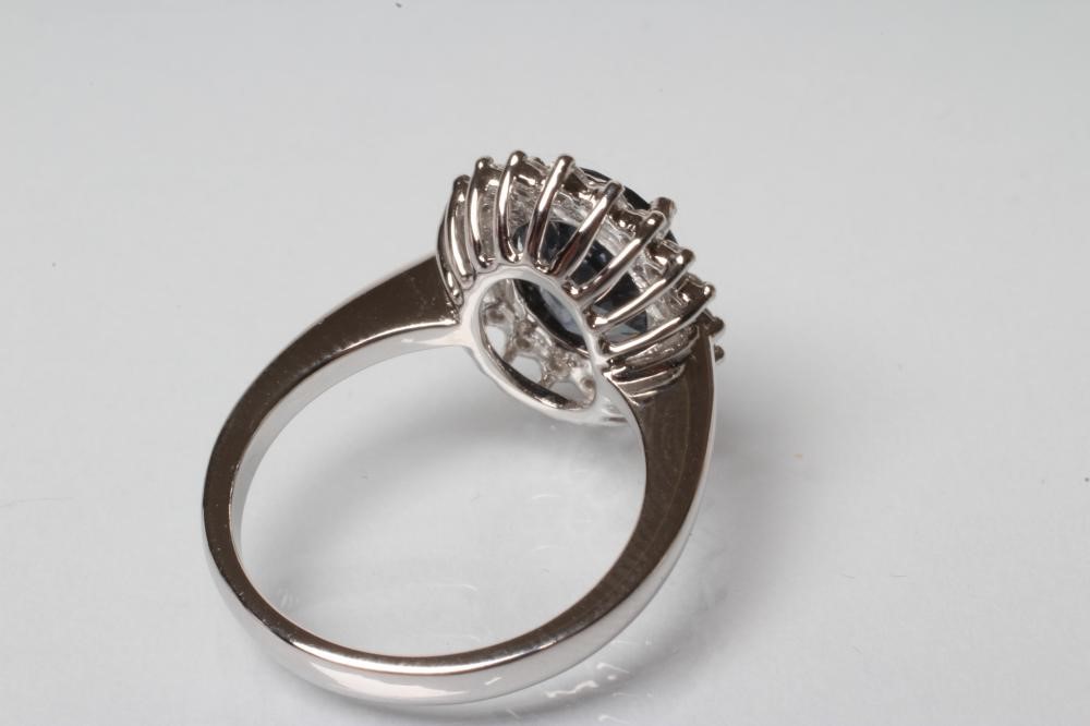 A SAPPHIRE AND DIAMOND CLUSTER RING Image